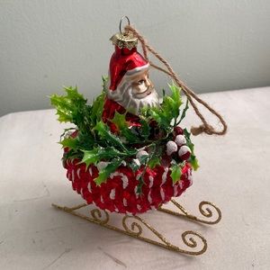 Santa Claus On pine cone sled ornament
